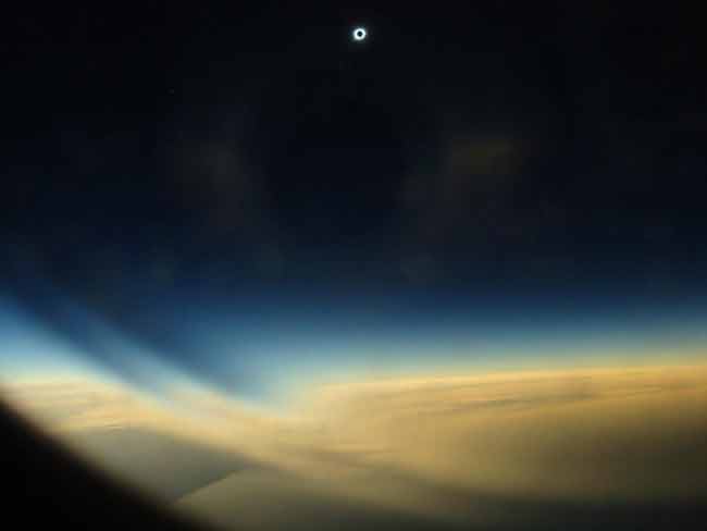 Aug. 1, 2008 solar eclipse 30-seconds into totality - the sun's corona, or atmosphere, shines high above the Arctic sky, while the moon's shadow casts a dark pall on the overcast below