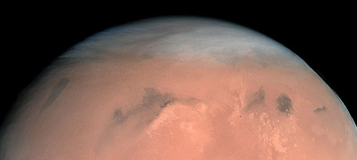 High, wispy clouds cover a large portion of Mars, seen in the first true-colour image of Mars generated with the OSIRIS orange (red), green and blue color filters
