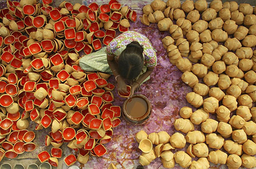 Diwali is marked by the lighting of lamps like these being prepared by a laborer in Amritsar