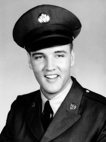 Elvis Presley smiles for a photo in his Army uniform