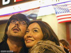 a German-speaking couple in Berlin watches the U.S. elections on TV late Tuesday night