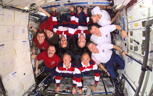 Expedition Three, STS-105 and Expedition crews assemble for a group photo in the Destiny laboratory on International Space Station