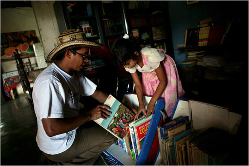 Luis Soriano, of La Gloria, Colombia, created the Biblioburro in the belief that the act of taking books to people who do not have them can somehow improve this impoverished region. His daughter Susana, 7, helped prepare books to be loaded on the two donkeys, Alfa and Beto, who regularly trek with him to bring books to rural communities