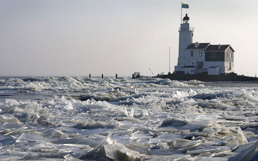 Marken lighthouse in northern Holland surrounded by ice sheets