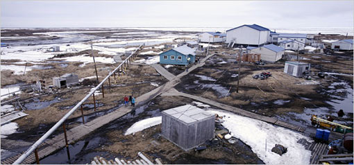 Newtok, Alaska, in spring, 2007, as viewed from its water tower. Boardwalks squish into the muck in Newtok, which erosion has turned into an island