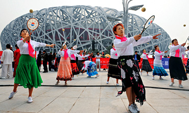 performers carry out their routine 100 days ahead of the Beijing Summer Games performers carry out their routine 100 days ahead of the Beijing Summer Games