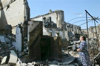 an South Ossetian woman looks at ruins in downtown Tskhinvali, capital of the separatist Georgian region, where Russian and Georgian forces fought a brutal five-day battle on Wednesday, Aug. 13, 2008 an South Ossetian woman looks at ruins in downtown Tskhinvali, capital of the separatist Georgian region, where Russian and Georgian forces fought a brutal five-day battle on Wednesday, Aug. 13, 2008