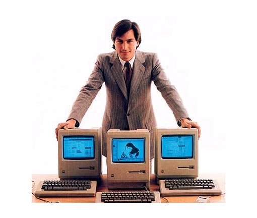 proud of his company's creations, Apple co-founder Steve Jobs shows off the original Macintosh as it was launched in January 1984