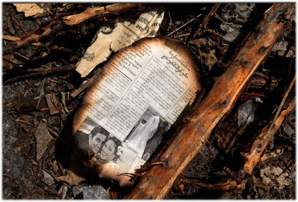 page from a wedding announcement clipping lies on the ground near a burned-out apartment block in Gori page from a wedding announcement clipping lies on the ground near a burned-out apartment block in Gori