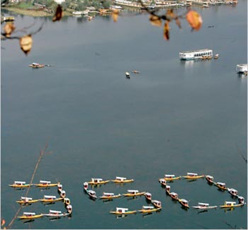 Boats in Srinagar, Kashmir. Organizers said their goal was to illustrate the urgent need to cut emissions by pointing out that the world passed the 350 mark two decades ago. The current concentration of carbon dioxide is 387 parts per million.
