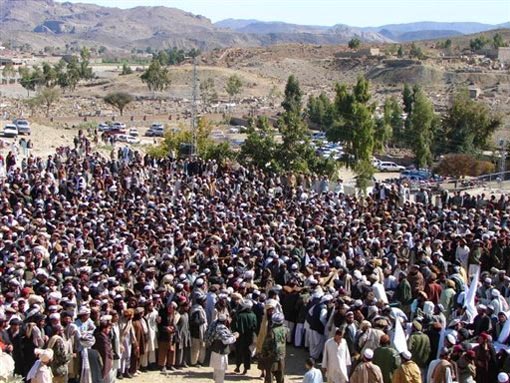 Pakistani tribesmen gather for funeral prayers for the victims of a missile strike
