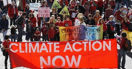 Protesters hold banners to demand for climate action in Sydney. Leaders will seek an ambitious mitigation outcome at Copenhagen to reduce the risks of global warming.