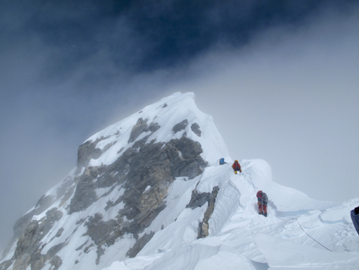halfway between the South Summit and the summit of Everest is a steep spur of rock and ice now called the Hillary Step
