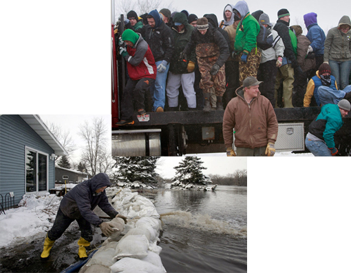 Russ Richards adds a sandbag onto the dike surrounding his home in Fargo, North Dakota, March 26, 2009. The dike protects the house from the flooding Red River.
