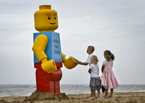 children play with a giant smiling Lego man that was fished out of the sea in the Dutch resort of Zandvoort in 2007