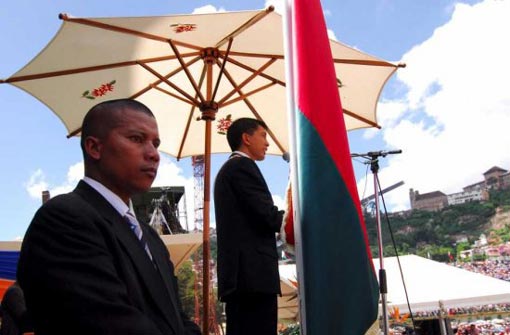 Madagascar President, Andry Rajoelina (rear) addresses supporters after he was formally installed as leader of the Indian Ocean island during a ceremony in Antananarivo, Madagascar, 21 March 2009. Tens of thousands of his supporters attended the ceremony at a sports arena in the capital, Antananarivo, but it was boycotted by many diplomats
