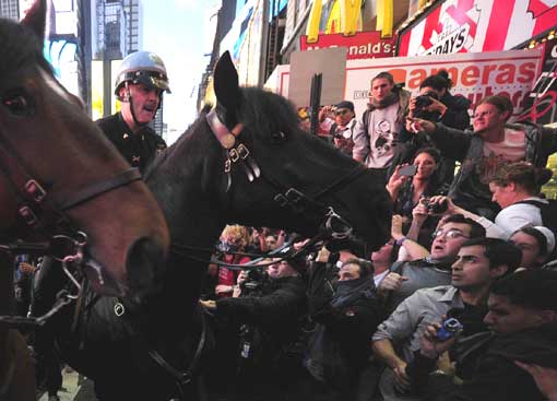 Mounted police try to stop Occupy Wall Street participants from breaking through barricades and spilling onto the street at Times Square in New York on Oct. 15. Thousands of demonstrators protesting corporate greed filled Times Square and dozens were arrested.