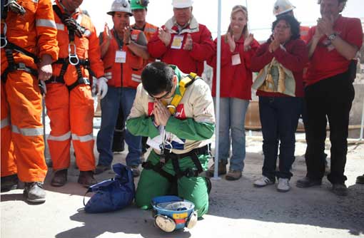rescued Chilean miner prays after being rescued from collapsed mine