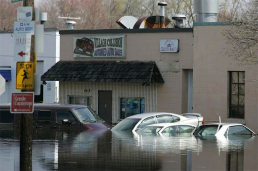 cars and businesses surrounded by flood waters in West Warwick, Rhode Island