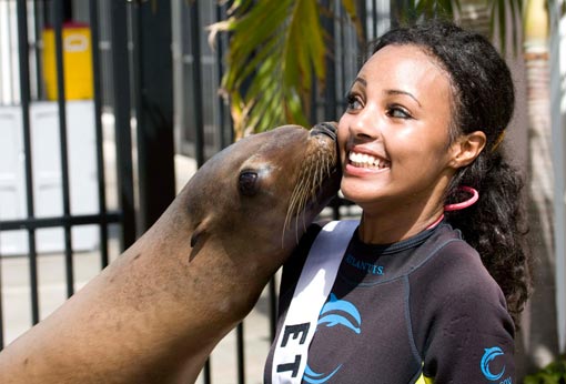 Melat Yante, Miss Ethiopia 2009, gets a kiss from Cassie the Sea Lion while in Dolphin Cay at ATLANTIS, Paradise Island, Bahamas, August 6, 2009.