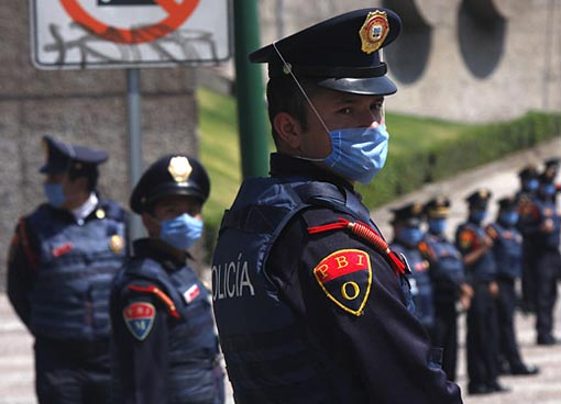 Riot police stand in front of Mexico's National Autonomous University soccer stadium. Despite being a sell-out, the famous volcanic-rock bleachers were empty due to the crisis