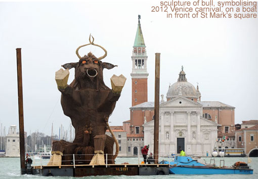 A sculpture of bull, symbolising the 2012 Venice carnival, is carried on a boat in front of St Mark's square