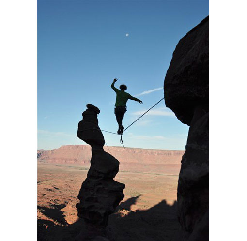slackliner high above the ground in Utah’s Moab Desert